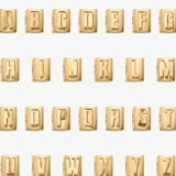 Gold letter blocks spelling out the alphabet on a white background
