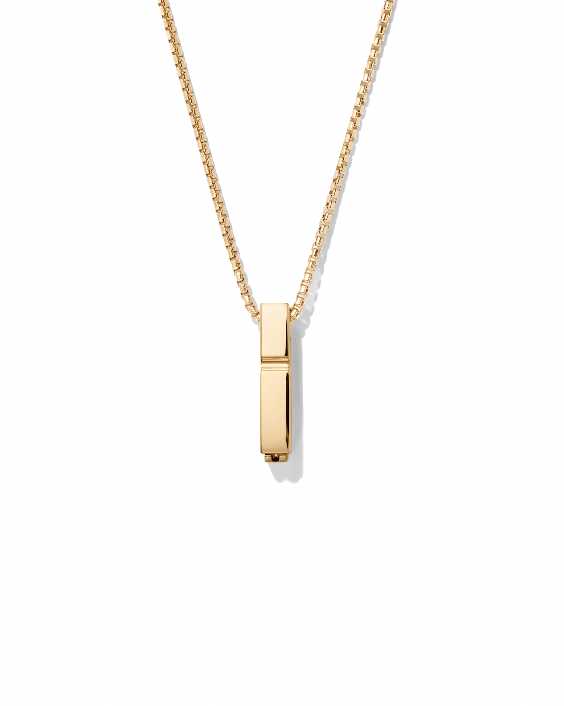 Gold necklace with a rectangular pendant on a white background