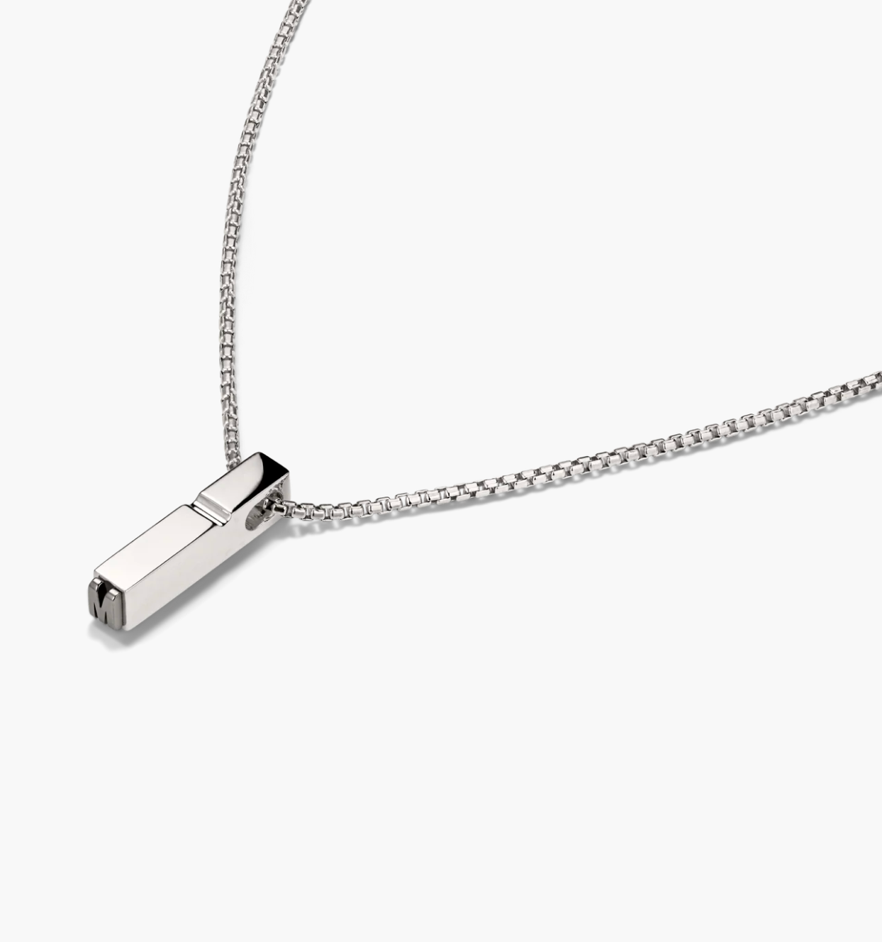 Silver necklace with a rectangular pendant on a white background