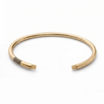 Gold vermeil open cuff with parallel black groove details near one end.