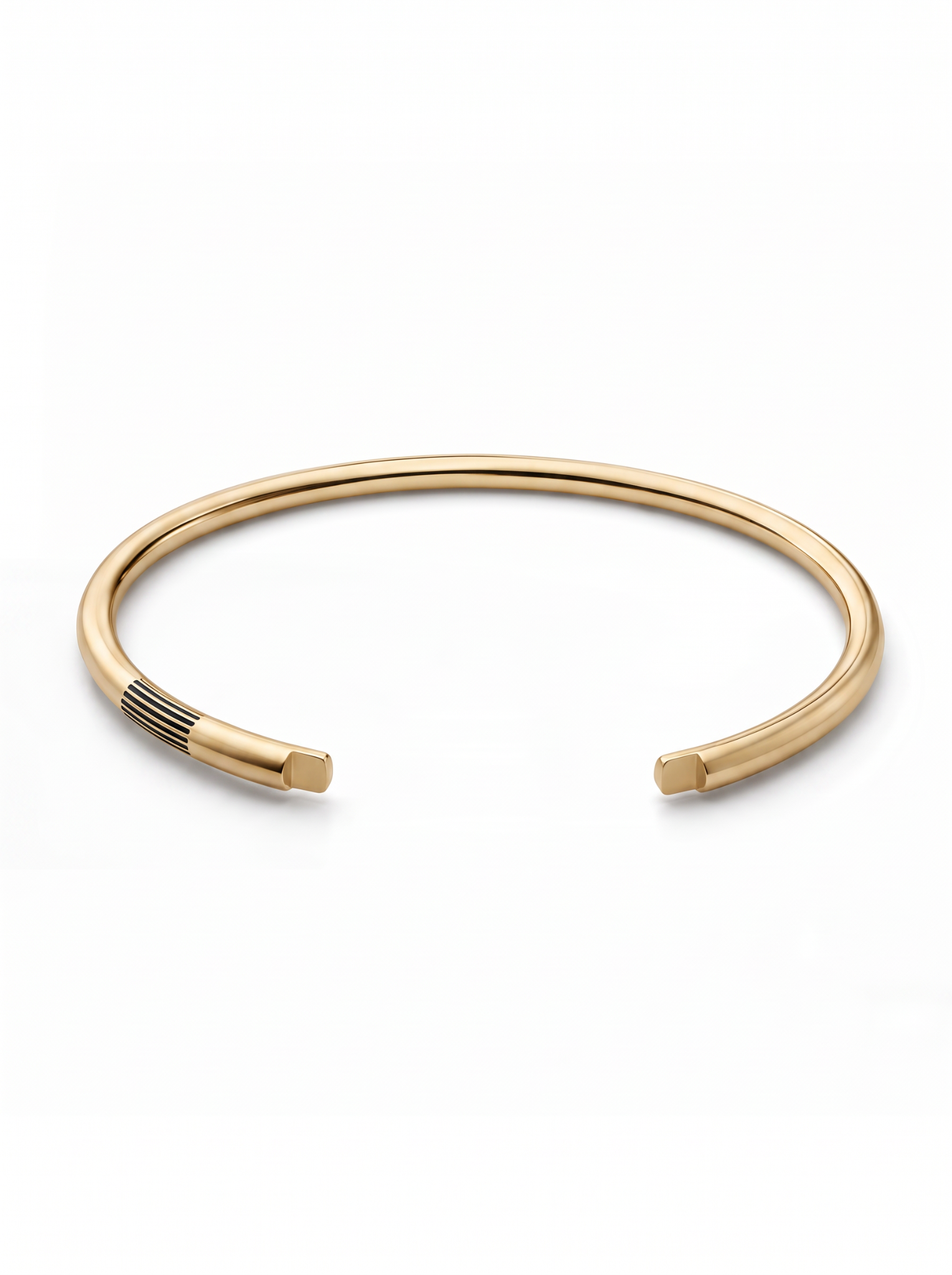 Gold vermeil open cuff with parallel black groove details near one end.