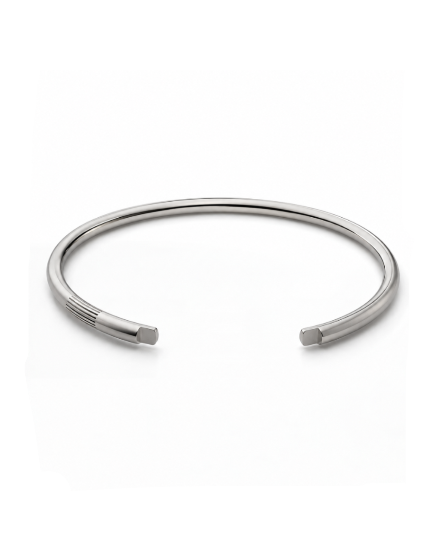 Polished sterling silver open cuff with parallel groove details near one end.