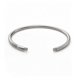 Polished sterling silver open cuff with parallel groove details near one end.